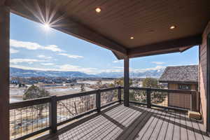 Snow covered deck featuring a mountain view