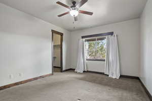 Carpeted empty room with ceiling fan