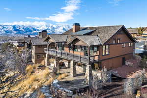 Back of house featuring a mountain view and a balcony