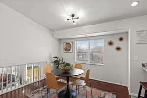 Dining area with wood-type flooring