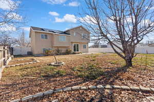 Rear view of property with solar panels and central AC