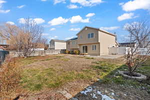 Back of property featuring a patio area and a lawn