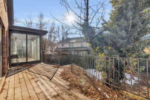 Wooden deck featuring a sunroom