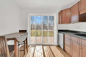 Kitchen with plenty of natural light, dishwasher, sink, and light tile patterned flooring