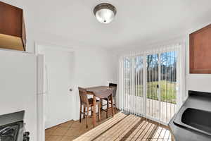 Dining area with sink and light tile patterned floors