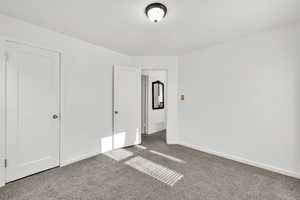 Unfurnished bedroom with carpet