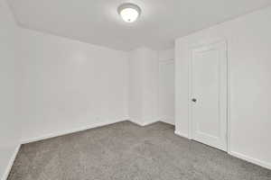 Unfurnished room with carpet