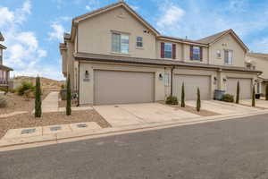 Townhome / multi-family property featuring a garage