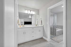 Bathroom with shower with separate bathtub and vanity