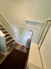 Staircase featuring hardwood / wood-style floors