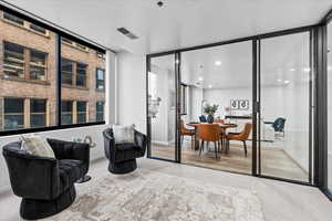 Living area featuring light colored carpet