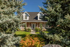 View of front of home featuring a front yard and a porch