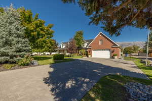 View of front of property with a front yard and a mountain view