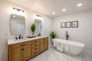 Bathroom with vanity and a tub