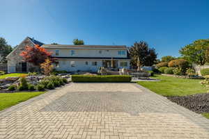 View of front of house featuring a front yard and a patio area