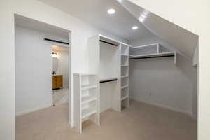 Walk in closet with light carpet