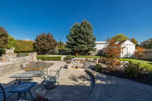 View of patio featuring a storage shed