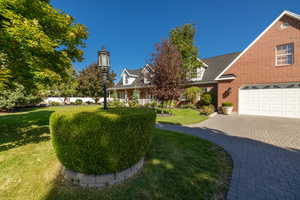 View of front of home with a front lawn and a garage