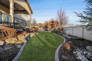 View of yard with a playground and ceiling fan