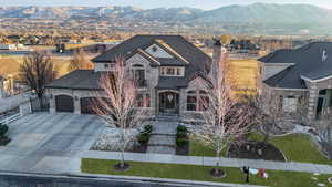 View of front of home with a garage and a mountain view