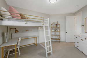 Unfurnished bedroom with light colored carpet