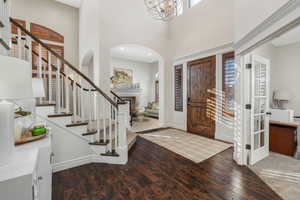 Entryway featuring a chandelier, a towering ceiling, and hardwood / wood-style floors