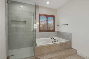 Bathroom featuring tile patterned floors and shower with separate bathtub