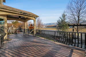 Wooden terrace with ceiling fan and a mountain view