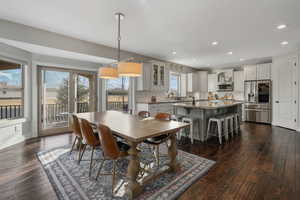 Dining space with sink and dark hardwood / wood-style floors