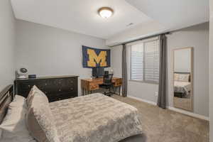 Bedroom with light colored carpet