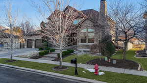 View of front of home featuring a front yard and a garage