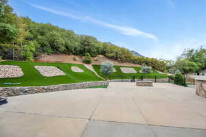 View of home's community with a lawn and a patio