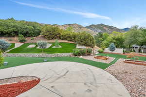 View of home's community featuring a mountain view and a yard