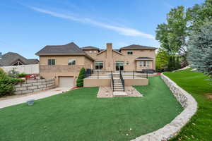 Back of property with a yard and a garage