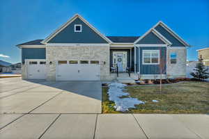 View of front of house with a garage and a front lawn