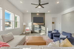 Living room with ceiling fan and light wood-type flooring