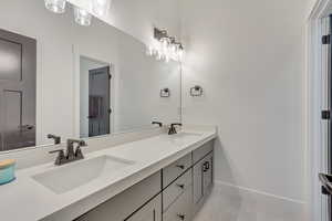 Bathroom featuring tile patterned flooring and vanity