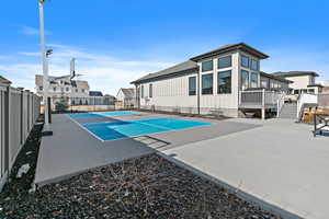 Exterior space featuring a wooden deck and basketball hoop