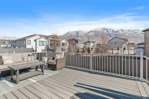 Wooden deck with a mountain view and outdoor lounge area