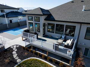 Rear view of house with a mountain view and basketball hoop