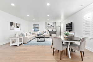 Dining space with light hardwood / wood-style flooring