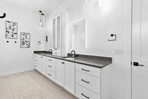 Bathroom featuring tile patterned floors and vanity