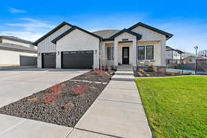 Modern farmhouse featuring a garage and a front yard