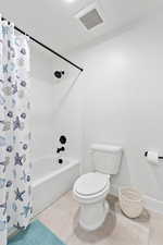 Bathroom with toilet and shower / bath combo