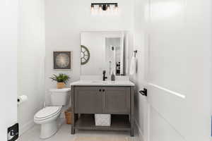 Bathroom with tile patterned floors, toilet, and vanity