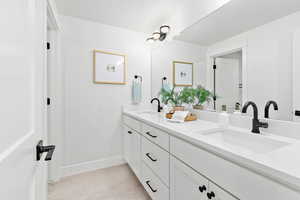 Bathroom featuring a textured ceiling and vanity