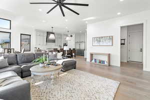 Living room featuring ceiling fan and light hardwood / wood-style floors