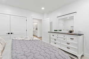 Bedroom with a closet and light hardwood / wood-style flooring