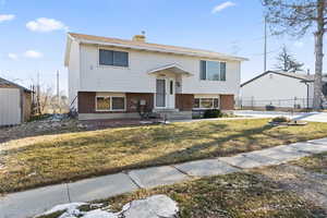 Split foyer home with a front yard