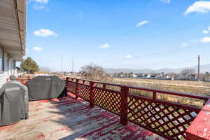 Wooden deck with grilling area and a mountain view